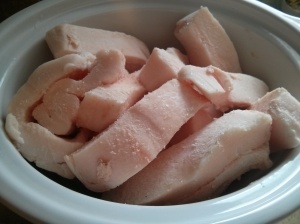 Pork fat in the slow cooker.